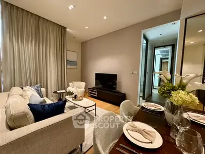Elegant living room with modern decor and cozy dining area, perfect for relaxation and entertaining.