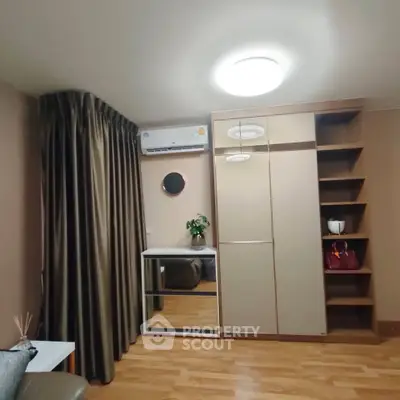 Modern bedroom with sleek wardrobe and air conditioning in stylish apartment
