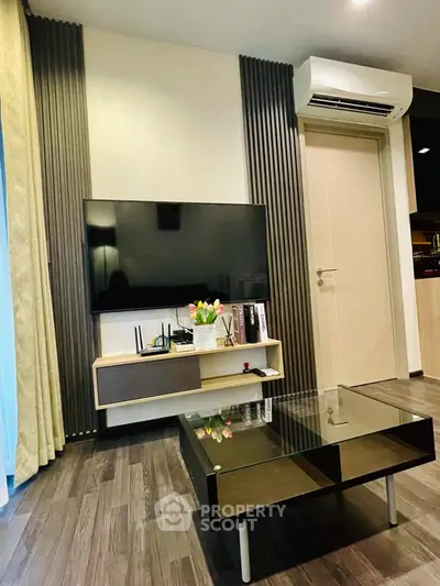 Elegant living room with modern furnishings, sleek TV unit, and cozy ambiance, perfect for relaxation and entertainment in a stylish home.