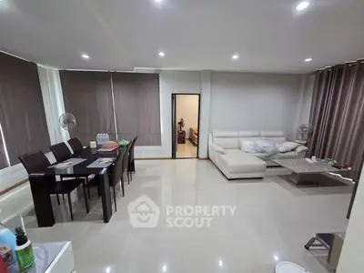 Spacious modern living room with dining area and sleek furnishings