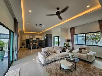 Luxurious open-plan living room with modern kitchen and elegant decor