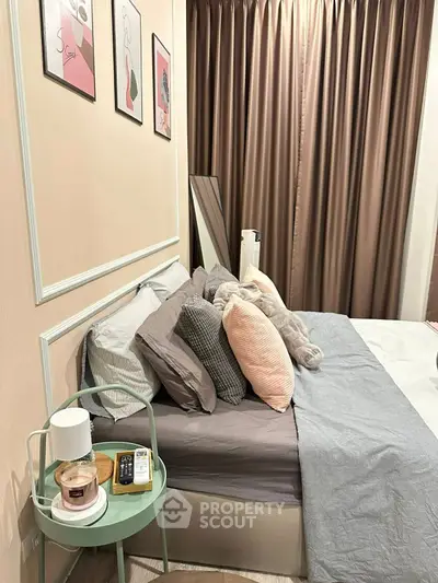 Cozy bedroom with stylish decor and plush pillows, perfect for relaxation.