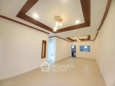 Spacious living room with elegant ceiling lights and tiled flooring