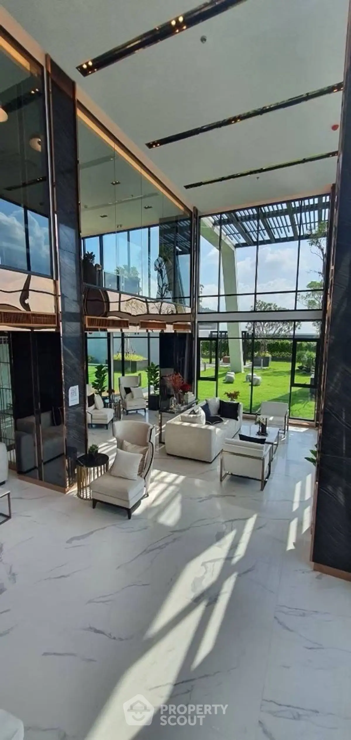 Luxurious modern living room with high ceilings and panoramic garden view