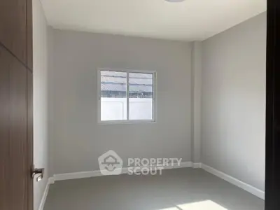 Bright empty room with window and tiled floor, perfect for customization.