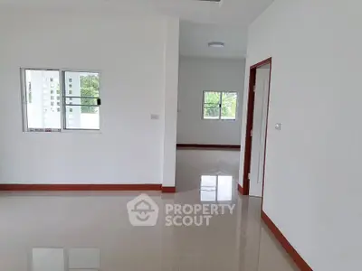 Spacious modern interior with glossy tiled floors and white walls, ideal for customization.