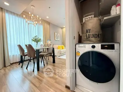Modern apartment with stylish dining area and in-unit laundry setup