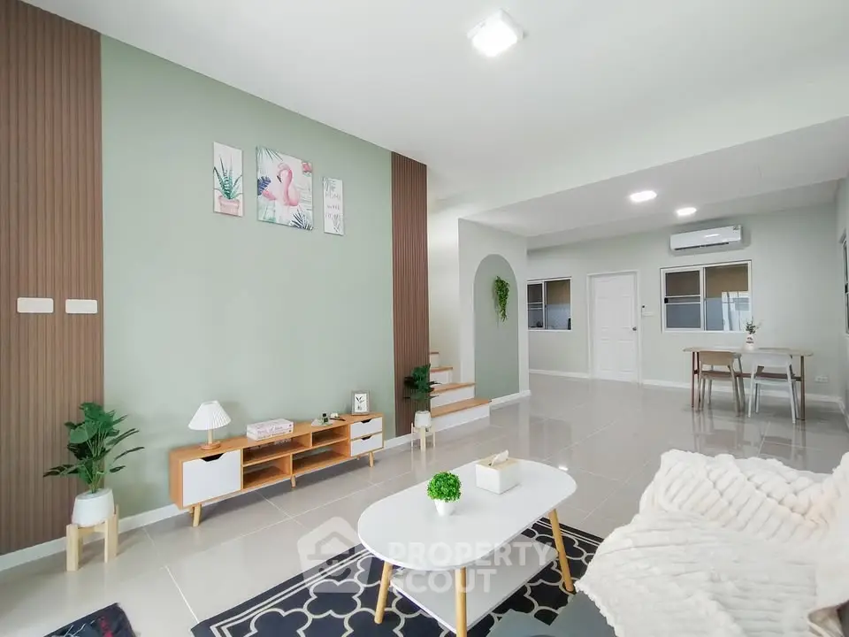 Modern living room with stylish decor and open layout, featuring a cozy seating area and elegant accents.