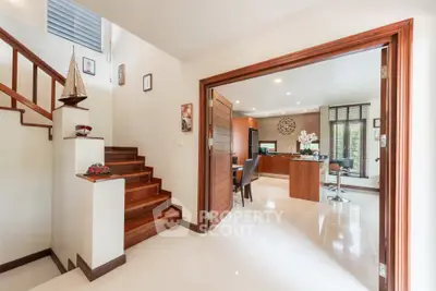 Spacious modern home interior with wooden staircase and open living area, perfect for family gatherings.