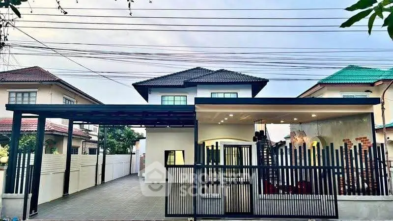 Modern two-story house with spacious driveway and stylish fence design