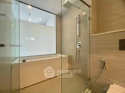 Luxurious modern bathroom with glass shower and sleek bathtub design