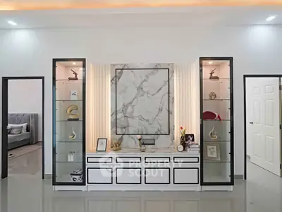 Elegant living room with modern marble feature wall and stylish shelving units.