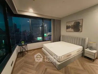 Luxurious bedroom with city view, featuring a stylish bed and elegant decor, perfect for urban living.