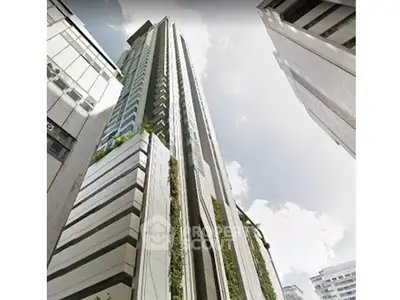 Stunning modern high-rise building with sleek architectural design in urban setting.