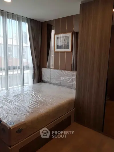 Modern bedroom with large window and stylish decor