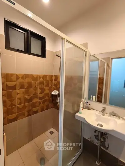Modern bathroom with stylish tile design and glass shower enclosure