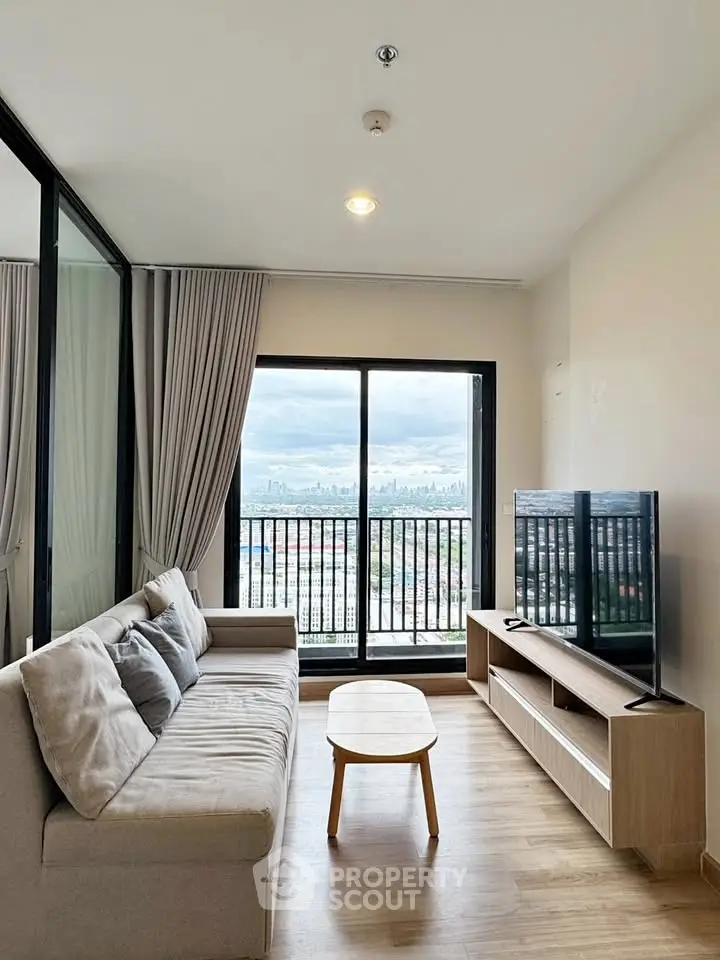 Modern living room with city view, cozy sofa, and large TV, perfect for relaxation.