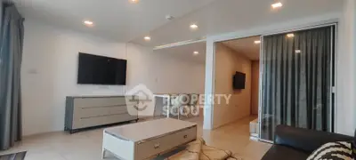 Modern living room with sleek furniture and open dining area, perfect for contemporary living.