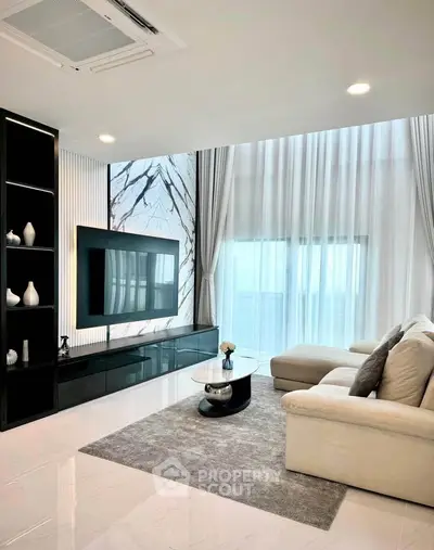 Luxurious modern living room with elegant decor and large windows