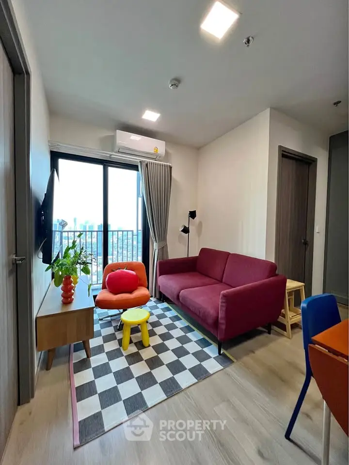 Modern living room with vibrant decor and city view from balcony.