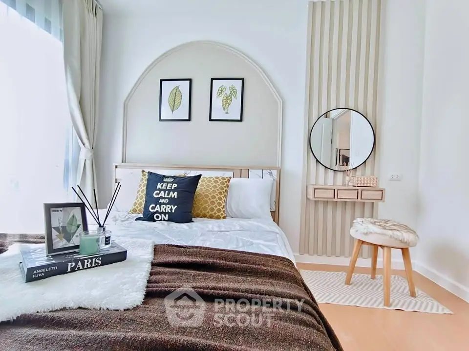 Chic and cozy bedroom with stylish decor and natural light, perfect for relaxation and comfort.