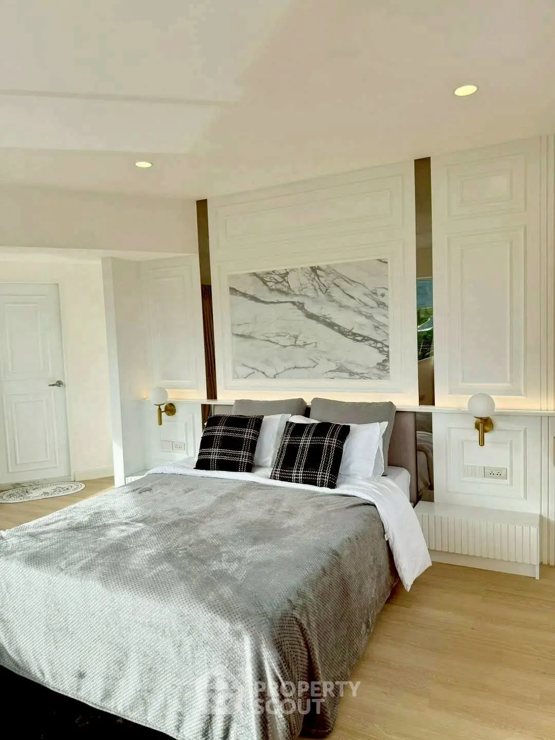 Luxurious bedroom with elegant decor and marble accent wall