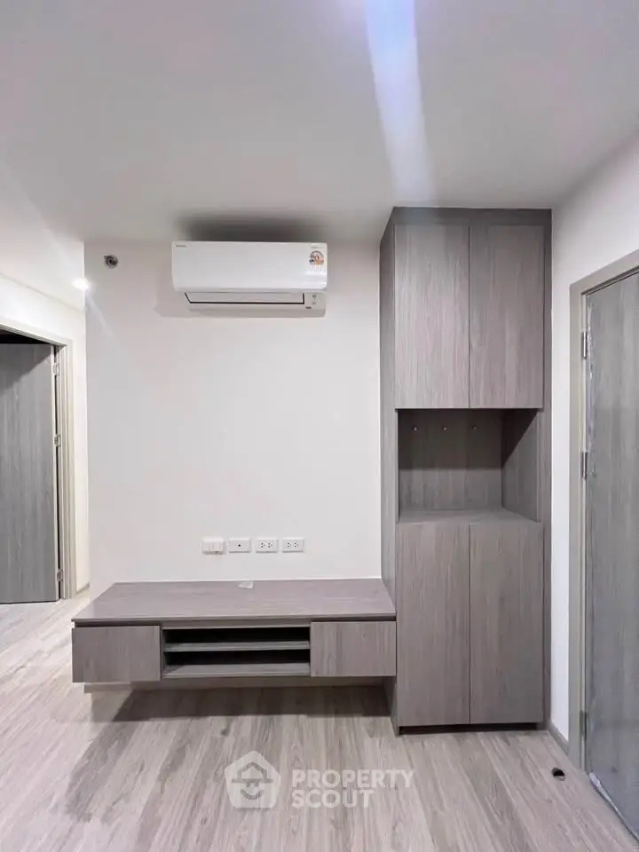 Modern minimalist living room with built-in storage and air conditioning