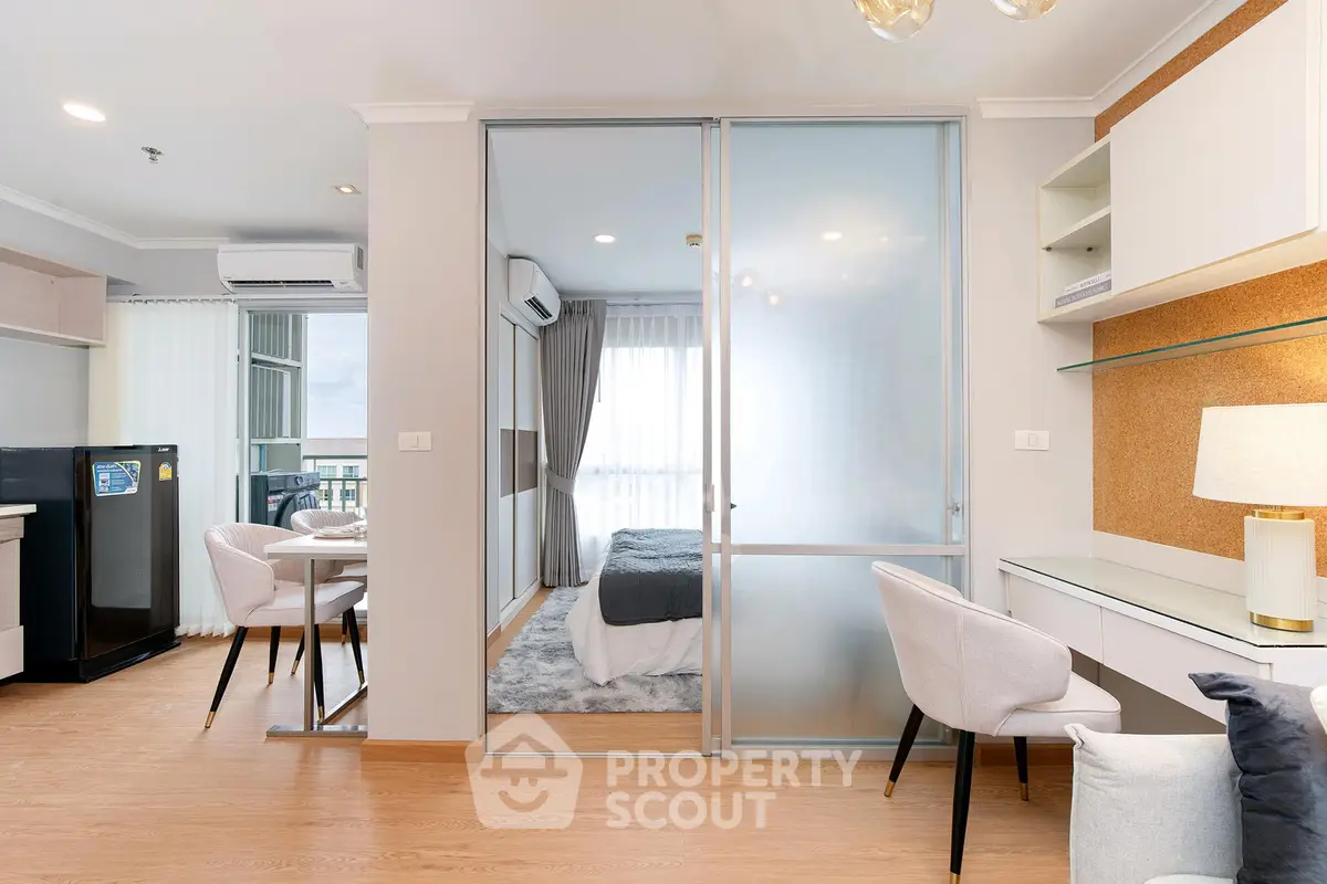 Modern apartment interior with open layout, featuring a cozy bedroom and stylish living area.