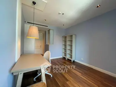 Spacious study room with wooden flooring and modern furniture