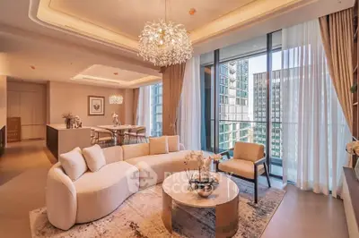 Luxurious modern living room with elegant lighting and city view, featuring a spacious open layout and stylish decor.