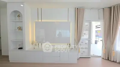 Modern living room with elegant built-in shelving and large windows for natural light.