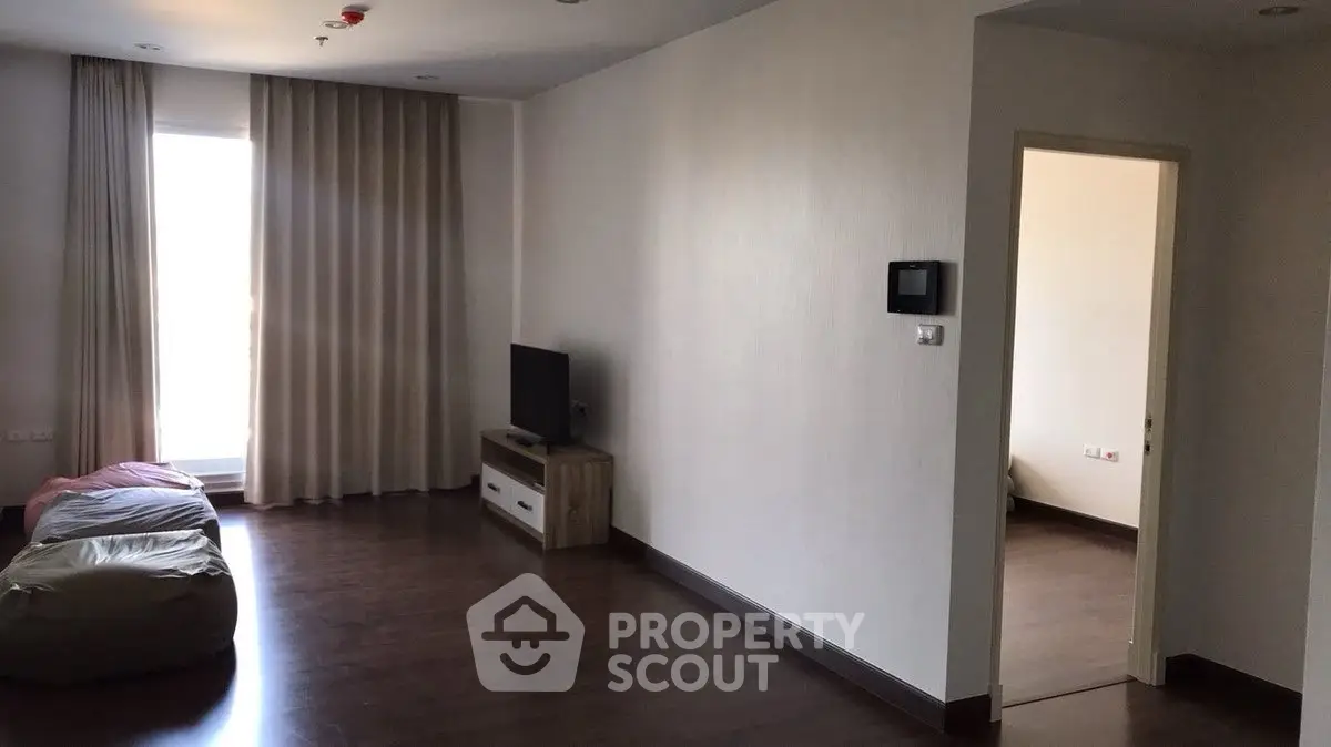 Spacious living room with modern decor and natural light