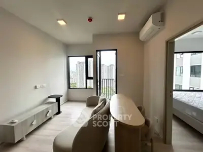 Modern living room with city view, featuring sleek furniture and natural light.