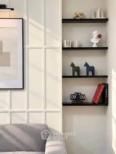 Stylish modern living room with elegant wall decor and cozy gray sofa