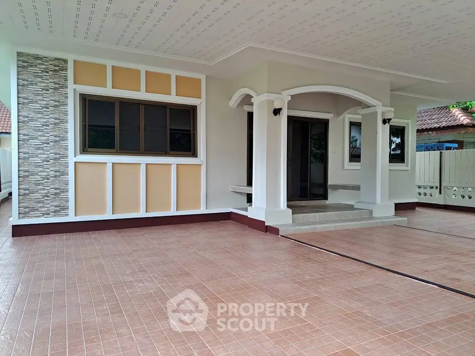 Charming house exterior with tiled patio and elegant entrance