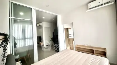Modern bedroom with sliding glass doors and air conditioning in a stylish apartment.