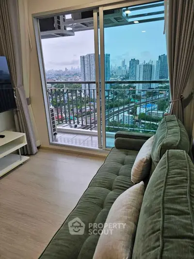 Modern living room with plush sofa and stunning city view from balcony.