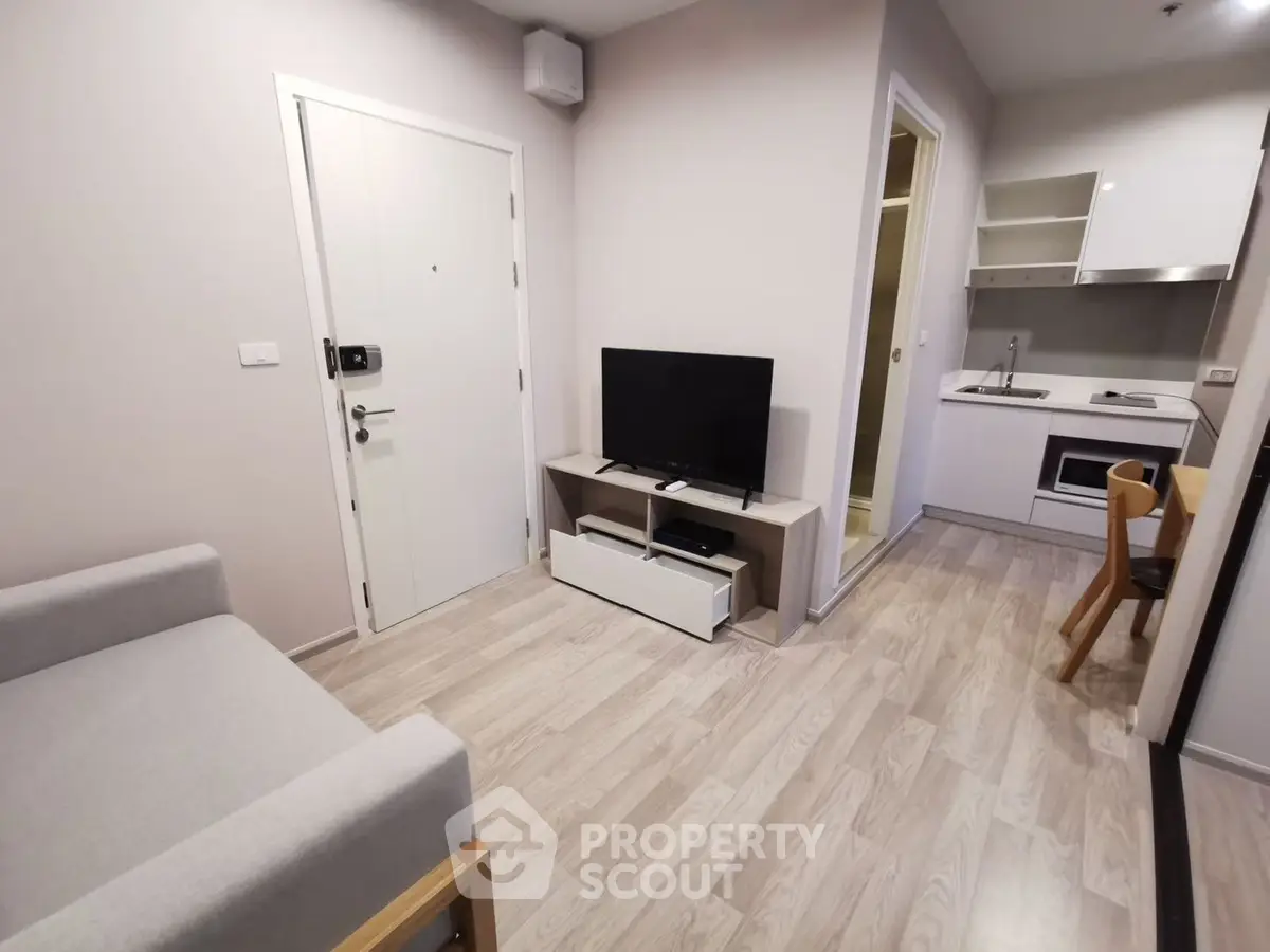 Modern compact living room with open kitchen in stylish apartment