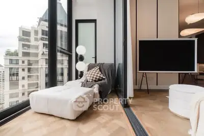 Modern living room with floor-to-ceiling windows and stylish decor in a high-rise apartment.