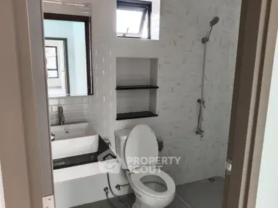 Modern bathroom with sleek white tiles and contemporary fixtures