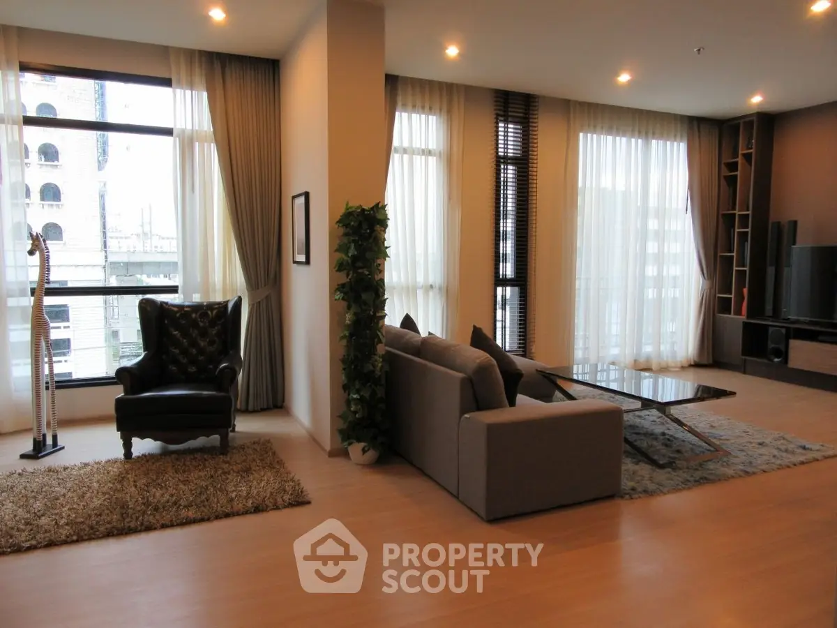 Spacious modern living room with large windows and stylish decor