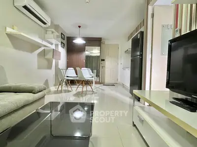 Modern living room with sleek furniture and open layout, featuring a cozy dining area and stylish decor.