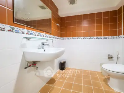 Spacious bathroom with modern fixtures and vibrant tile design