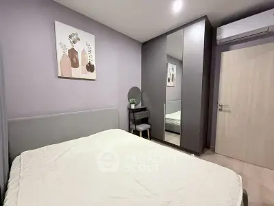 Cozy modern bedroom with stylish decor and mirrored wardrobe