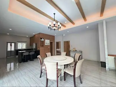 Spacious modern dining area with elegant chandelier and open layout