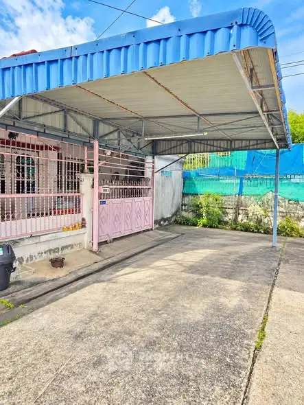 Charming residential property with spacious driveway and covered carport, perfect for family living.