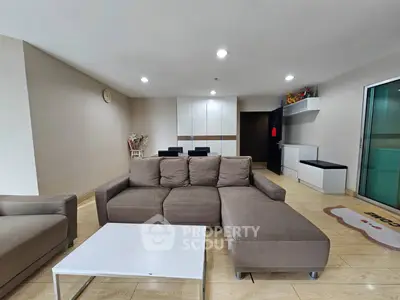 Spacious modern living room with neutral tones and sleek furniture