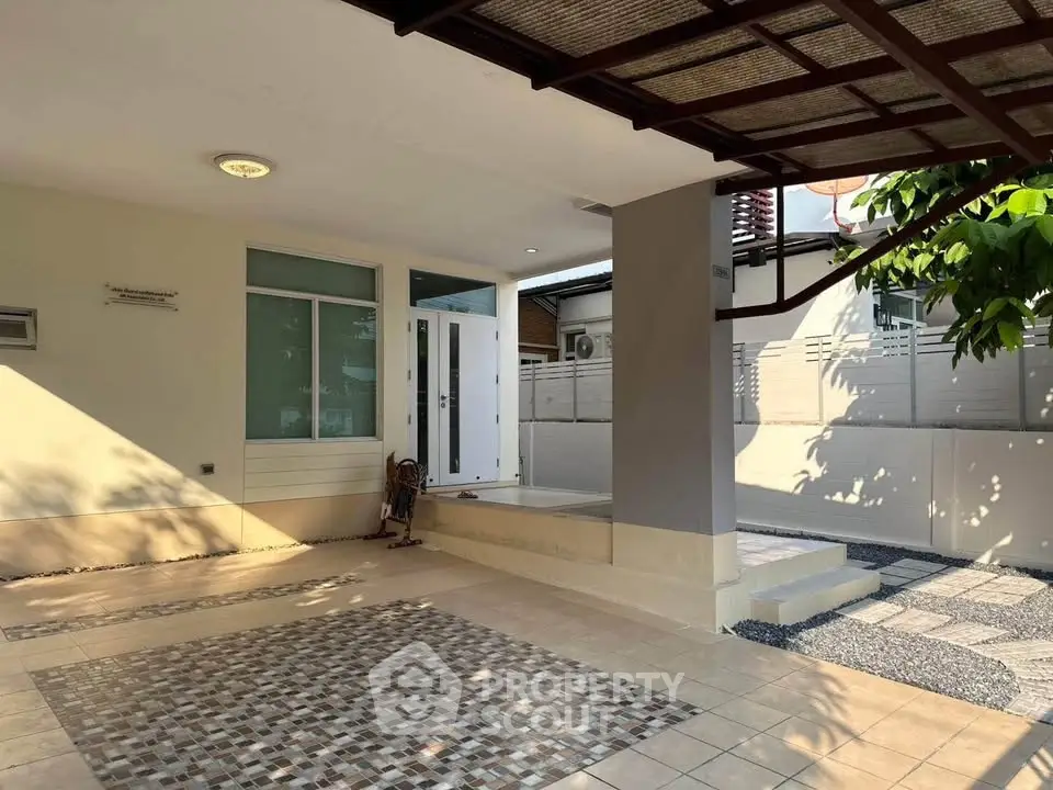 Spacious modern home entrance with tiled flooring and natural light
