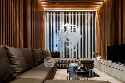 Luxurious modern living room with unique artistic wall design and elegant decor.