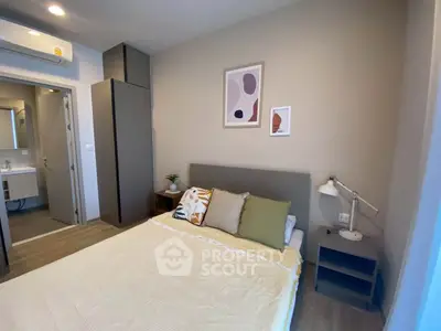 Modern bedroom with cozy decor and ensuite bathroom in stylish apartment
